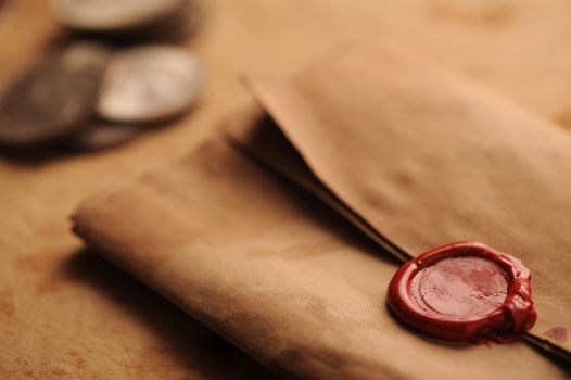 wax seal on a grunge paper, old coins on background