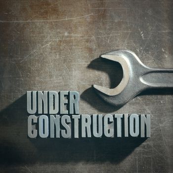 Under Construction sign with a metallic background texture