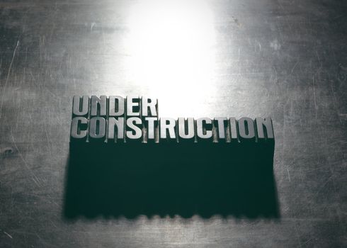 Under Construction sign with a metallic background texture