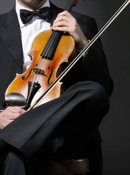 an elegant violinist with his violin