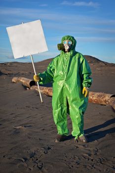 Scientist chemist with a placard in his hand in the area of chemical contamination