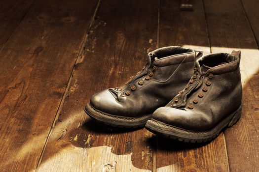 Old boots on the wooden floor, copy space