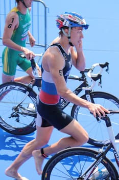 Two athlets running next to their bikes at transition space at the International Geneva Triathlon, on July 22, 2012 in Geneva, Switzerland.