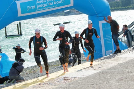 Group of unidentified female athlets going out of water at the 2012 International Geneva Triathlon, Switzerland.