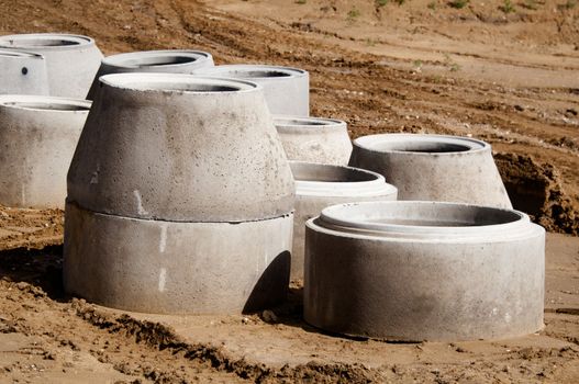 concrete drainage pipes on a construction site for a highway extension