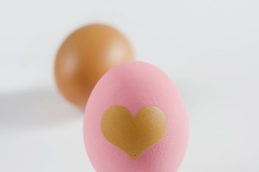Preserved egg with heart shape and brown eggs