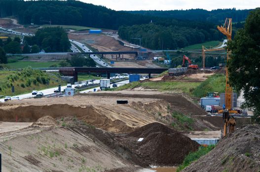 ZUSMARSHAUSEN, GERMANY – JULY 15: Construction site of the extension of A8 highway from currently 4 to 6 lanes at Zusmarshausen, Germany on July 15, 2012. Heavy machinery is used for this massive project happening in a timeframe of over 2 years.