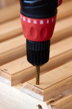 Power Tool Drilling Down a Screw into Wood