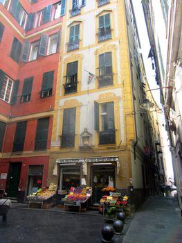 Square with a fruit and vegetables store in Genoa                          