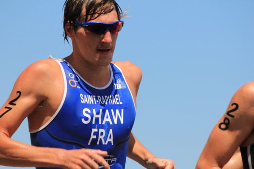 GENEVA, SWITZERLAND - JULY 22 : one athlete running  at the international Geneva Triathlon, on july 22, 2012 in Geneva, 