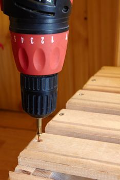 Power Tool Drilling Down a Screw into Wood