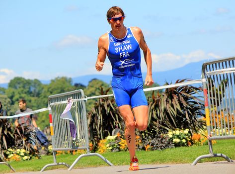 GENEVA, SWITZERLAND - JULY 22 : one athlete running  at the international Geneva Triathlon, on july 22, 2012 in Geneva, 