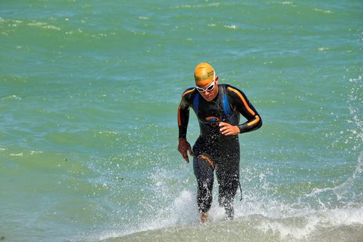 GENEVA, SWITZERLAND - JULY 22 : one unidentified male runner after the swimm race at the international Geneva Triathlon, on july 22, 2012 in Geneva, Switzerland