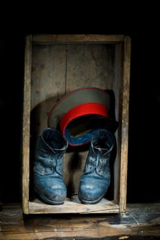 Stock photo: an image of old boots and a hat in a box