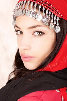 Pretty young woman cover with traditional red scarf