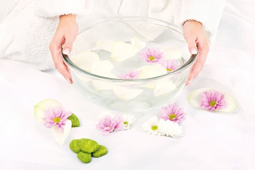 Woman's hands and petal bath