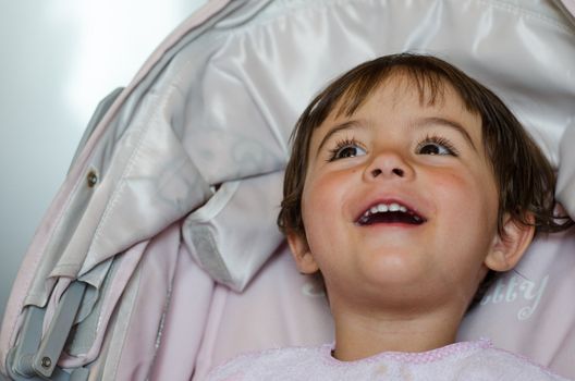 Happy baby face smiling in the Stroller, Italy