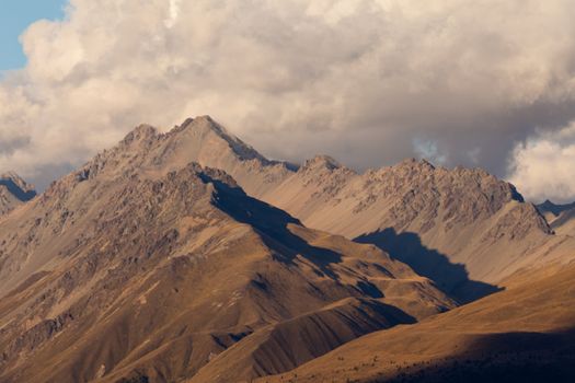 Thunderstorm brewing over rugged mountain ridges with alpine tundra above timberline