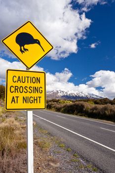 New Zealand Road Sign Attention Kiwi Crossing at road near active volcano of Mount Ruapehu in Tongariro National Park