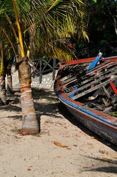 Abandoned wooden fishing boat on a tropical island.
