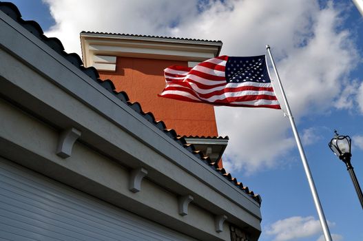 An American flag waving in front of a building.