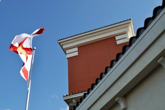 Florida state flag waving in front of a building.