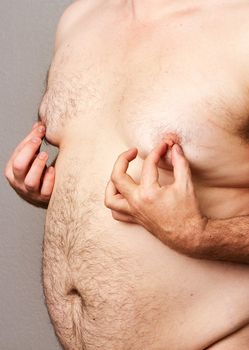 Heavy set man putting his nipples between his fingers and pinching twisting or rubbing away at them