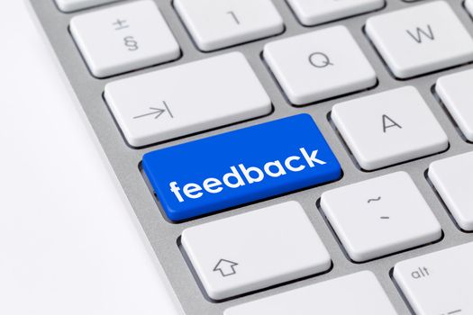 Photo of a computer keyboard with a single blue key with the word “feedback” symbolising customer interaction and satisfaction.