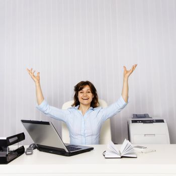 Happy young woman in the office workplace