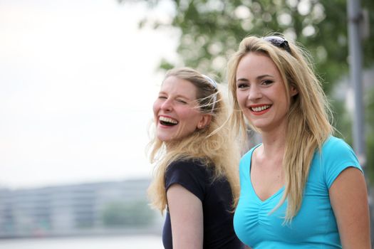 Spontaneity and laughter amongst friends as two young woman enjoy a laugh together Spontaneity and laughter amongst friends as two young woman enjoy a laugh together