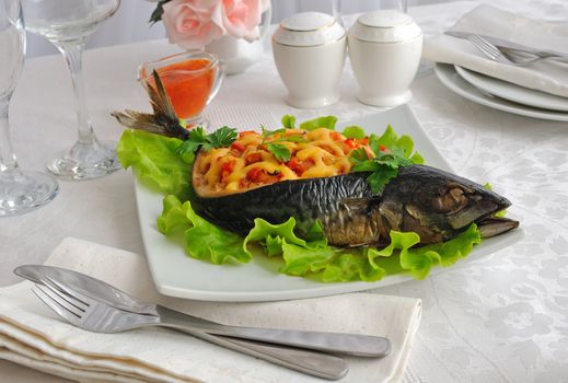 Mackerel stuffed with vegetables and cheese with lettuce