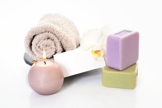 Spa and wellness setting with natural soap, candles and towel. Beige dayspa