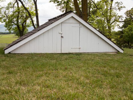 Old antique ice house underground in garden in rural area