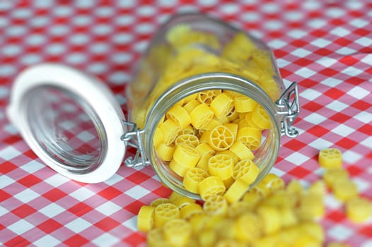 An image of bright yellow pasta in a jar