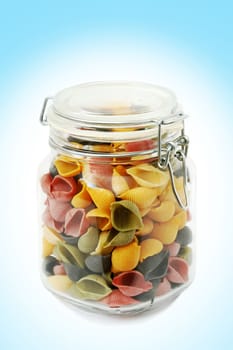 An image of colorfull pasta in glass jar
