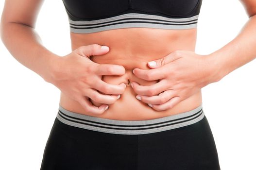 Woman suffering from stomach pain, isolated in white, strong backlight