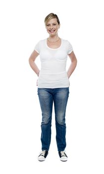 Casual trendy female with hands in jeans pocket, full length portrait
