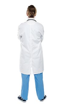 Back view of a female doctor looking at white. Full length shot