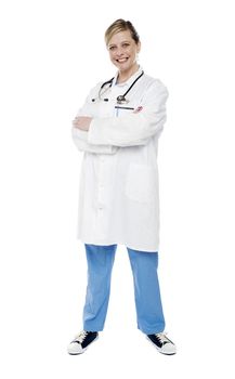 Female physician standing with crossed arms isolated against white background