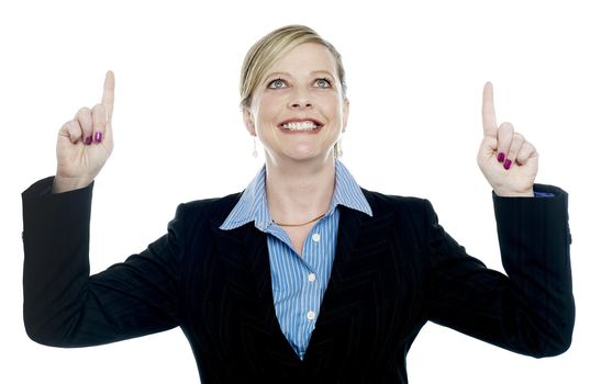 Corporate lady pointing upwards with both hands and looking up as well