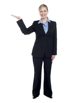 Smiling corporate lady presenting copy space, full length portrait