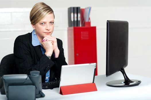 Serious business lady looking right into camera. Thinking hard in mind