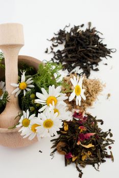 An image of mortar with flowers and tea