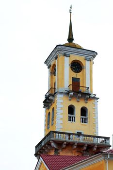 An image of a yellow clock tower