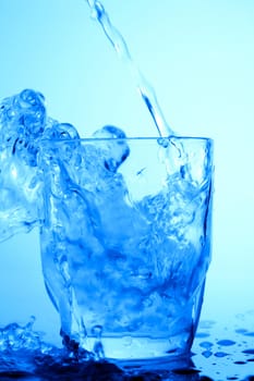 Food theme: image of water splash in blue glass