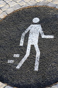 White pedestrian sign on the street, warning message