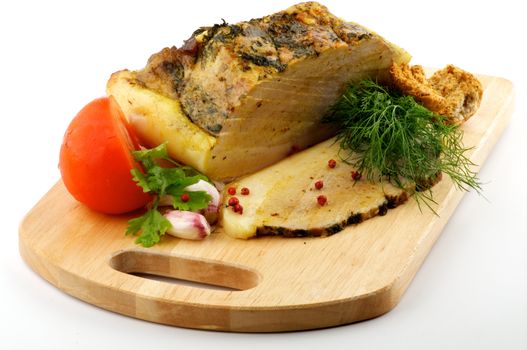 Homemade Roast Pork with Dill, Parsley, Garlic and Tomato on wooden cutting Board