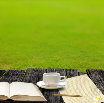 Write a letter with coffee cup in the garden
