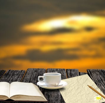Coffee cup with blank book and note paper in morning time