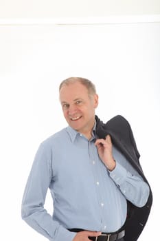 Casual middle-aged businessman standing with his jacket slung over his shoulder isolated on white